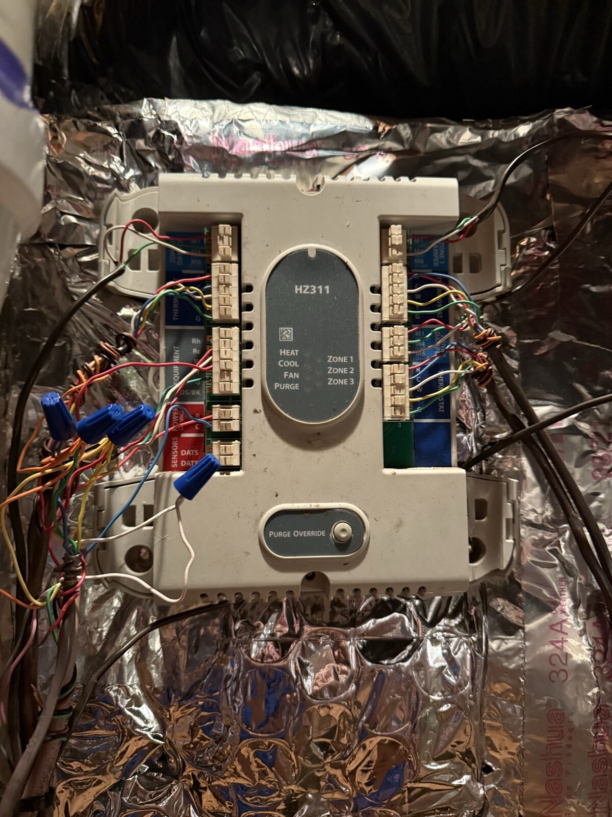 Exposed zone-control board with dozens of color-coded thermostat wires